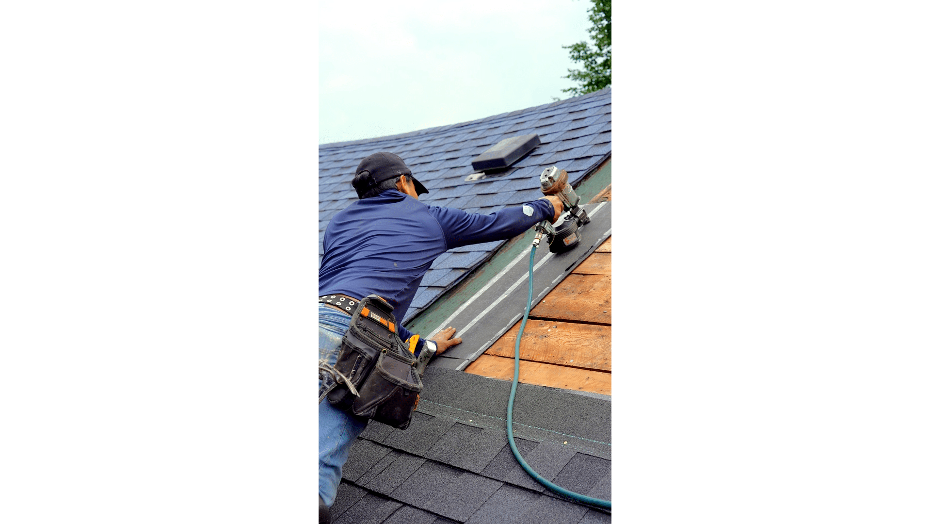 A Trusted Roofers Toronto expert secures asphalt shingles on a residential roof, ensuring a durable and weather-resistant installation.